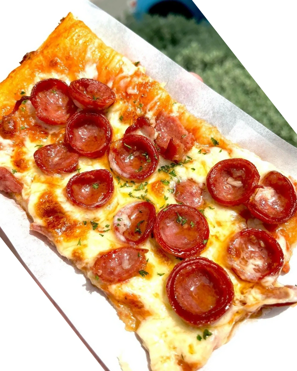 A slice of pepperoni pizza from Pizza Please, Italian Jamaican restaurant in Kingston Jamaica