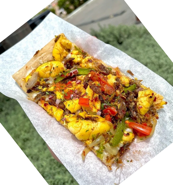A slice of ackee and red herring (ackee and saltfish) pizza from Pizza Please, Italian Jamaican rest