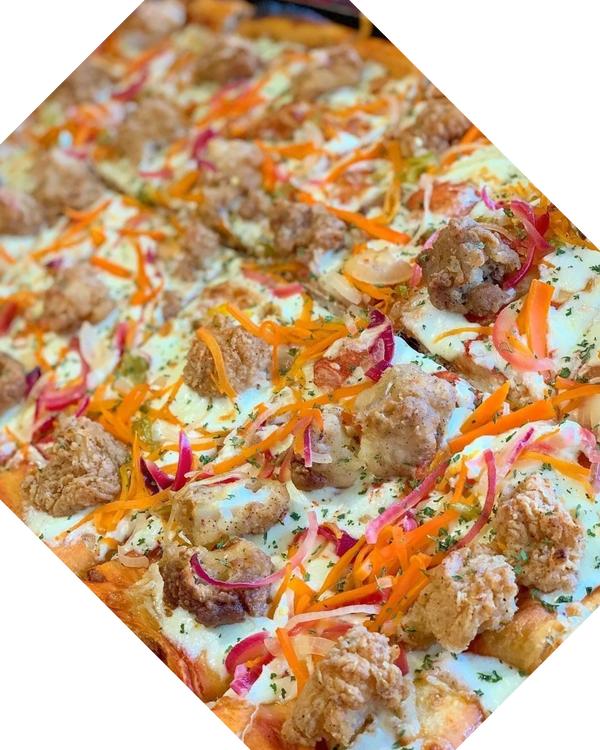 A tray of escovitched fish pizza from Pizza Please, Italian Jamaican restaurant in Kingston Jamaica