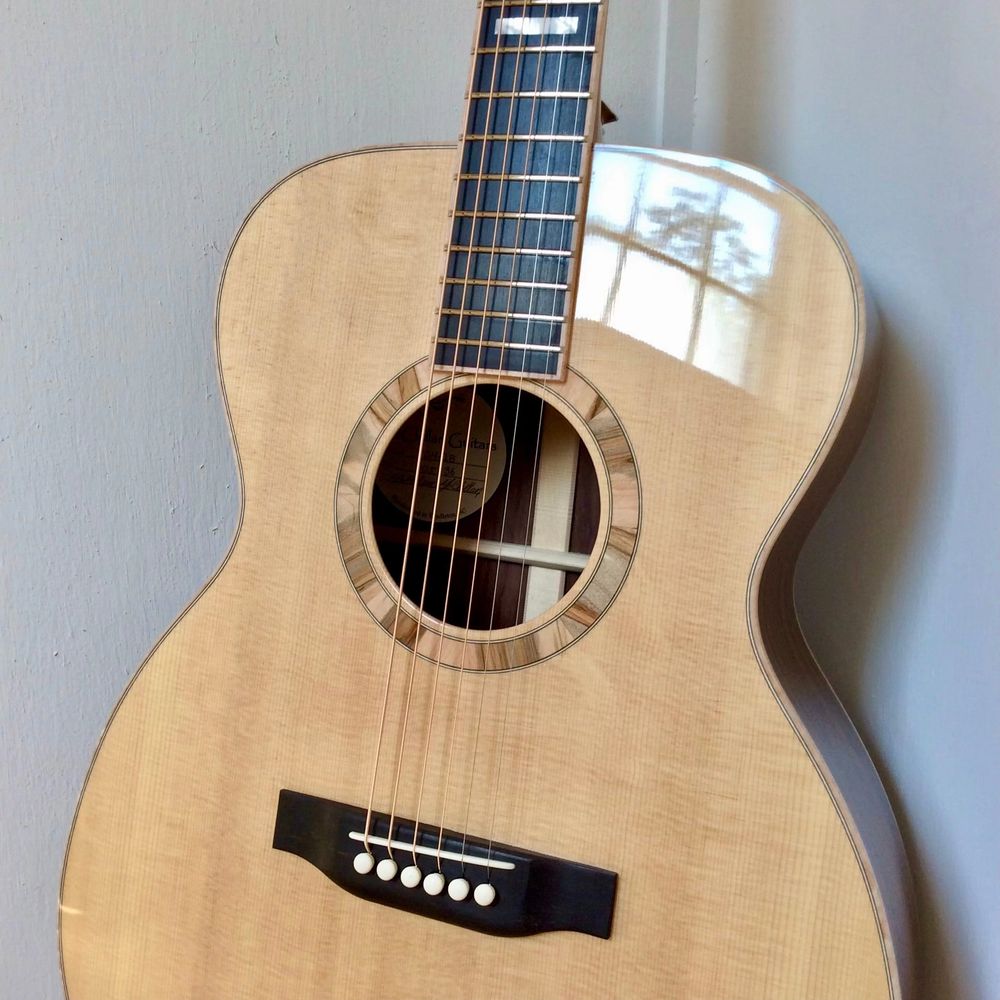 Close-up of a McClellan Guitar with the multicolor ambrosia maple rosette highlighted. 