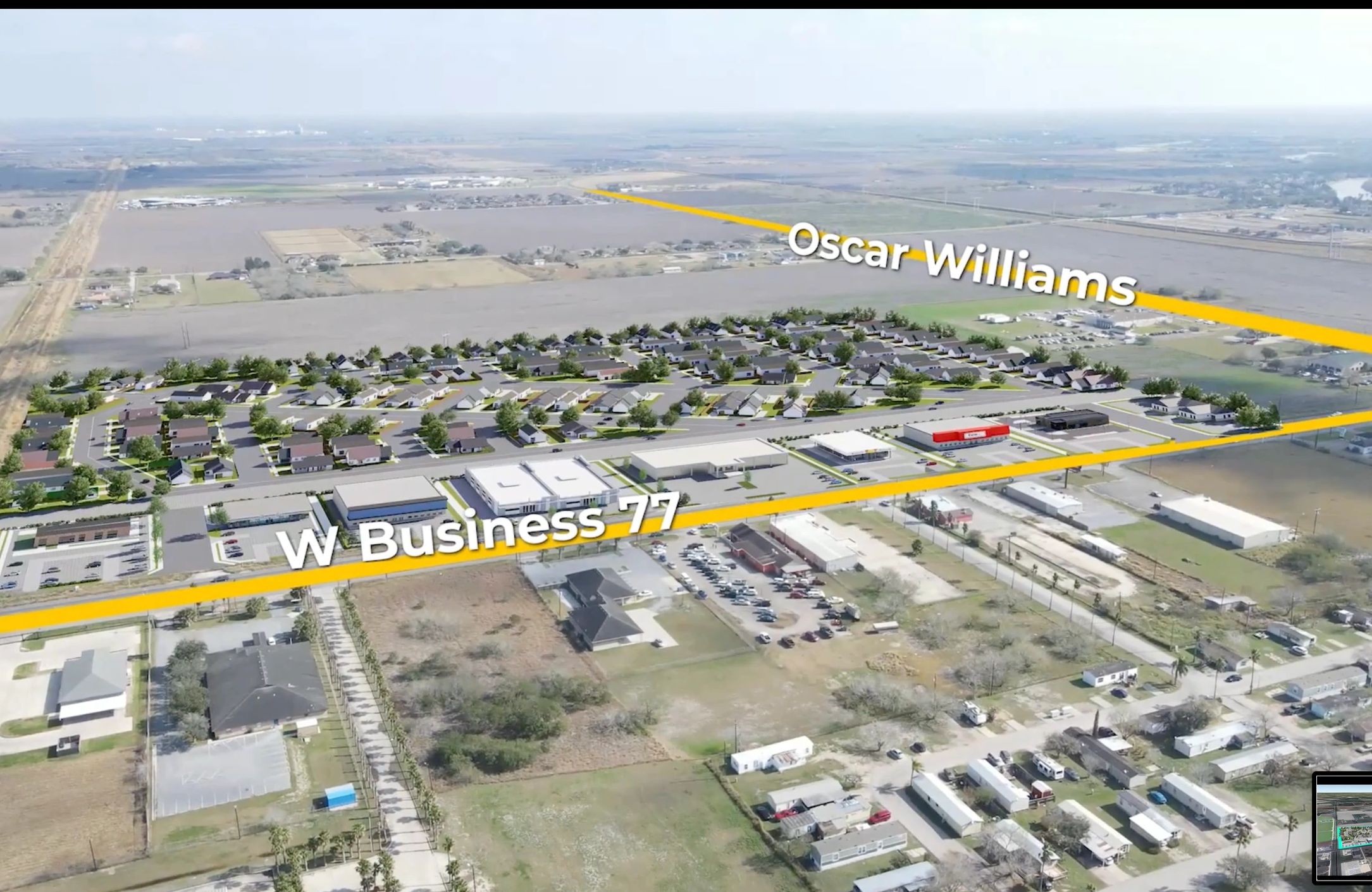 Aerial view of a residential and commercial area near W Business 77 and Oscar Williams roads.