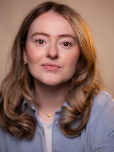 Portrait of a young woman with light brown hair and a calm expression.