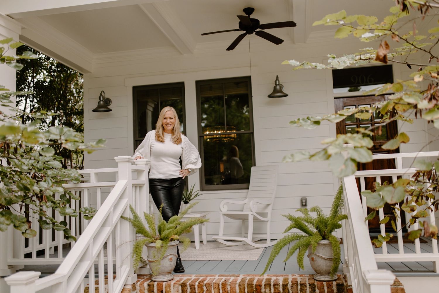 Donna Wright Realtor standing on a white porch at a home in Houston, TX.