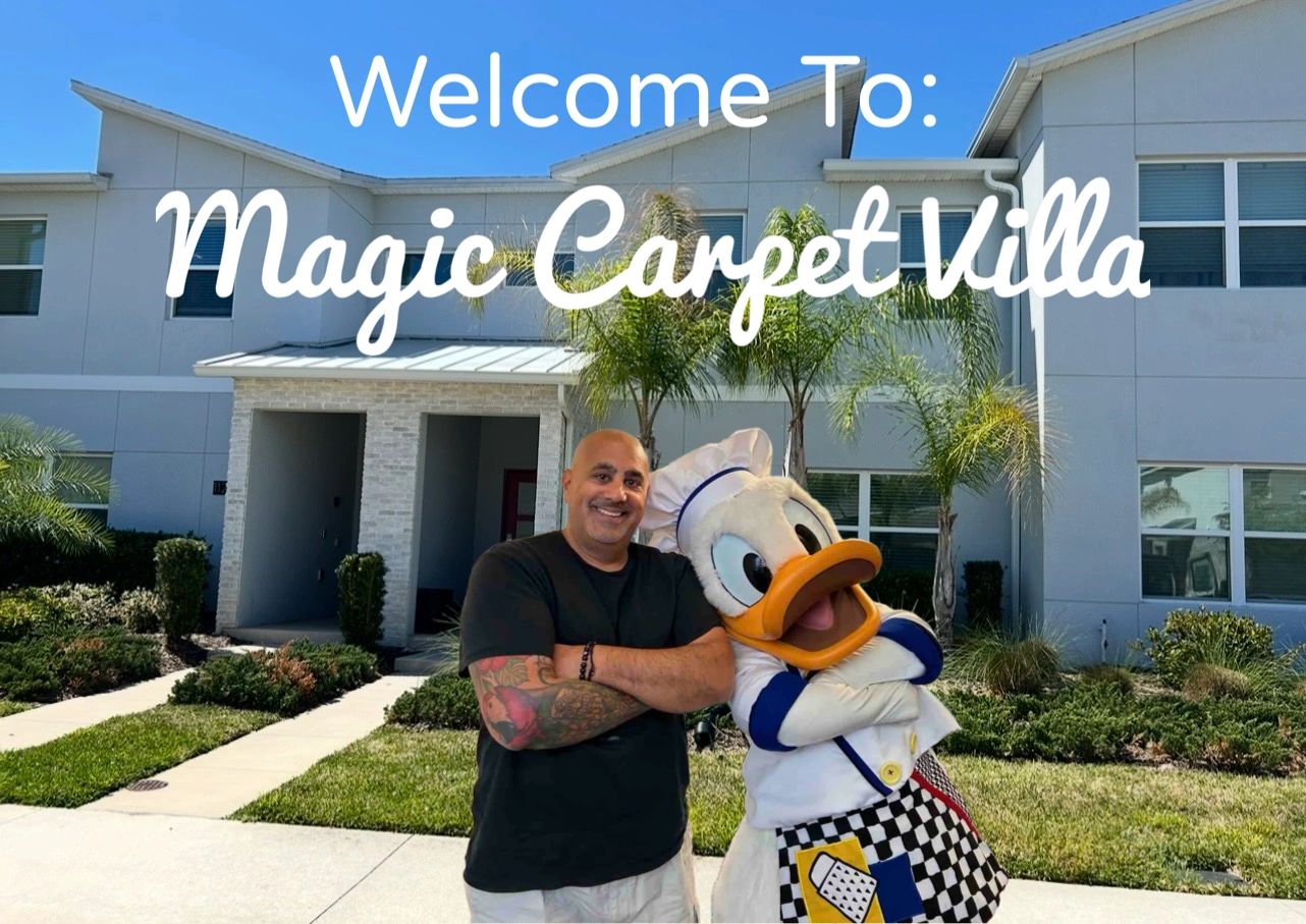 Man and Donald Duck mascot outside Magic Carpet Villa