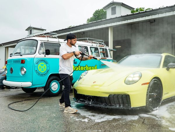Owner of Motorhead washing a new Porsche 911 at the Road America Race Track in Plymouth, WI. 