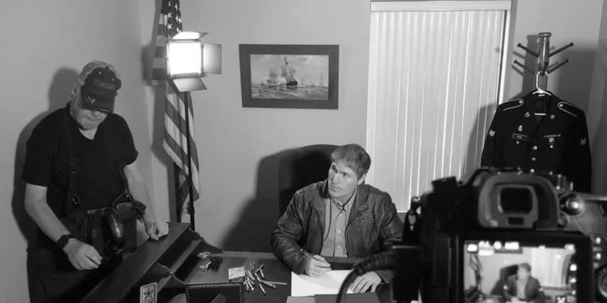 Spanish Interpreter Gabe Kirk seated at desk in officce.