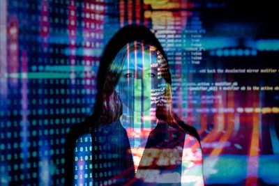 AI coding overlaid with woman in foreground
