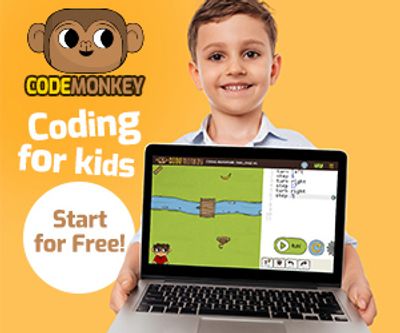 Smiling boy holding a laptop