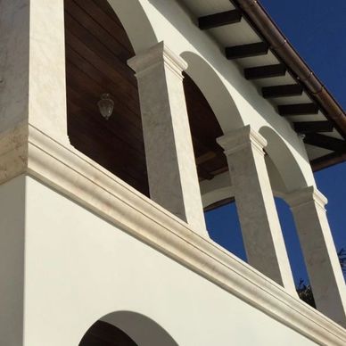 White stone arches and columns on a building facade.