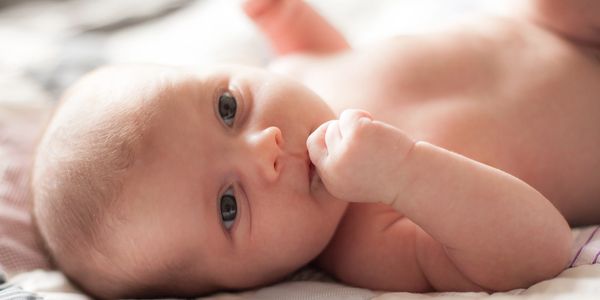 Postpartum doula changing baby's diaper
