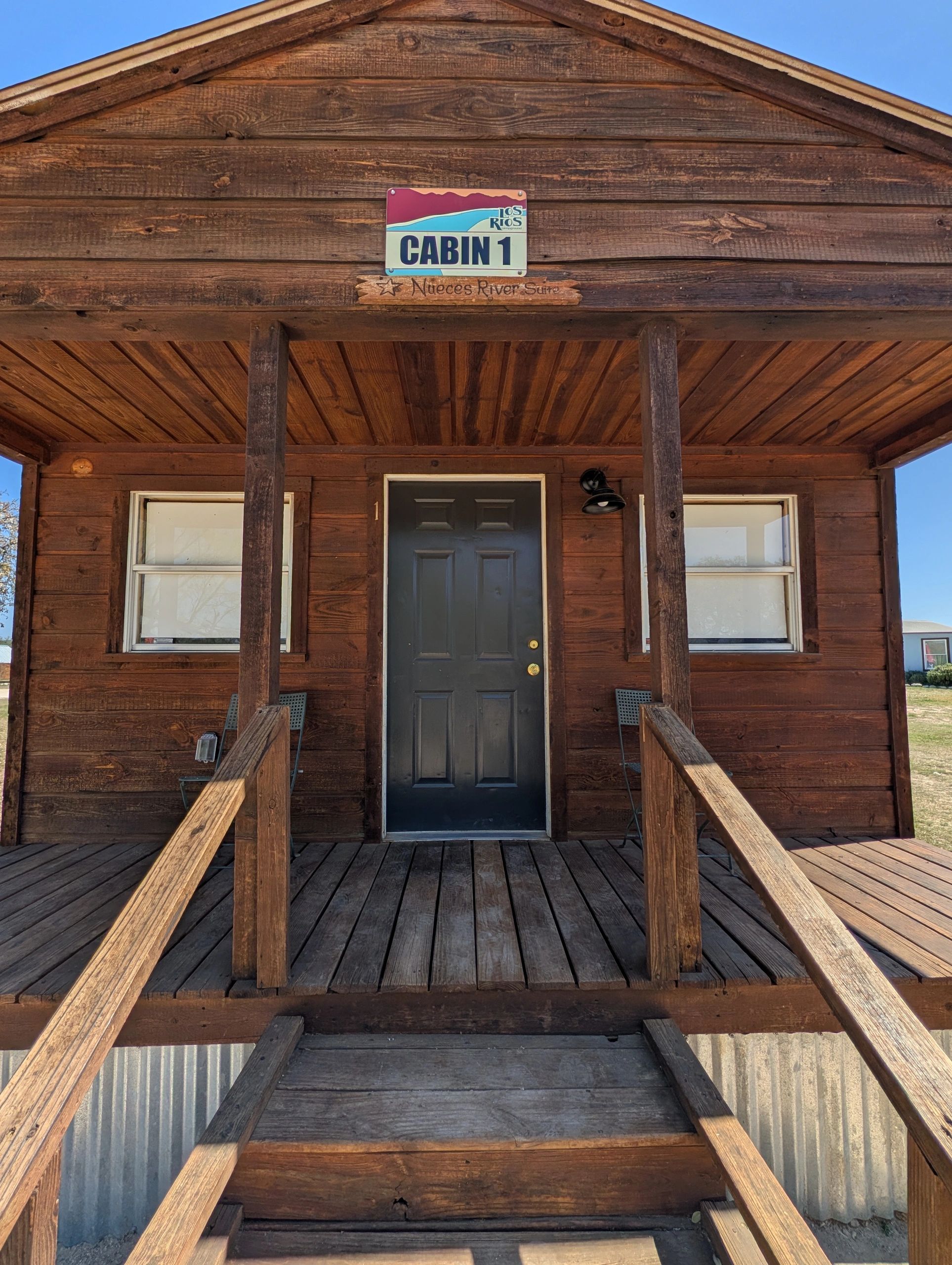 Front view of a rustic wooden cabin labeled Cabin 1.