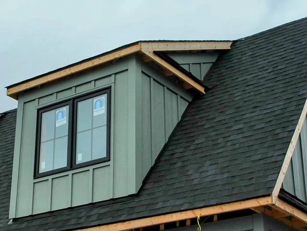 New dormer window installation on house roof.