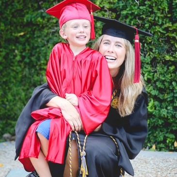A mother and son in their graduation caps and gowns.