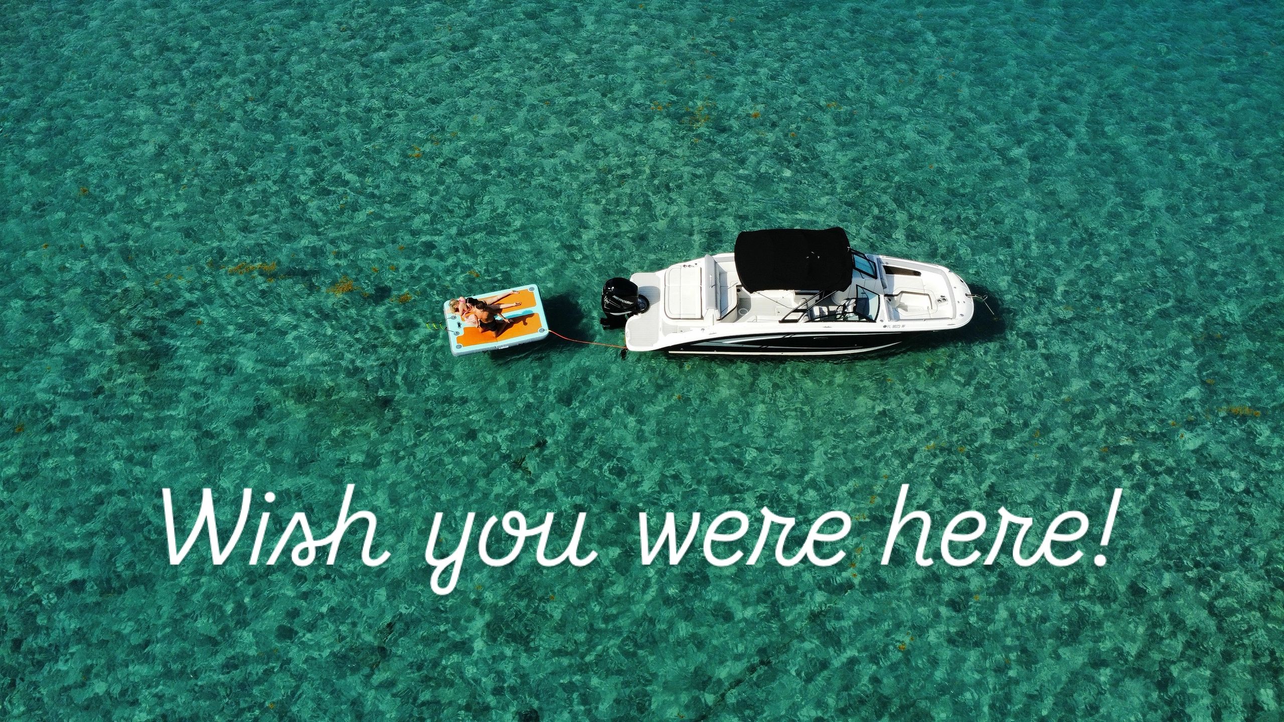 Private boat charter in calm blue tropical water at Peanut Island sandbar.