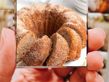 A hand holding a photo of a cinnamon sugar bundt cake.