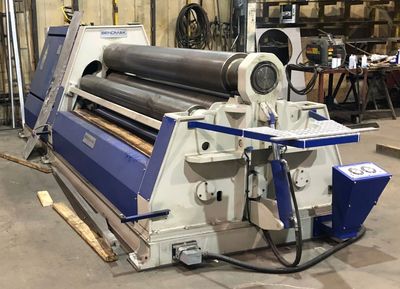 Industrial metal rolling machine in a workshop.