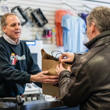 A person handing over the bag to the customer