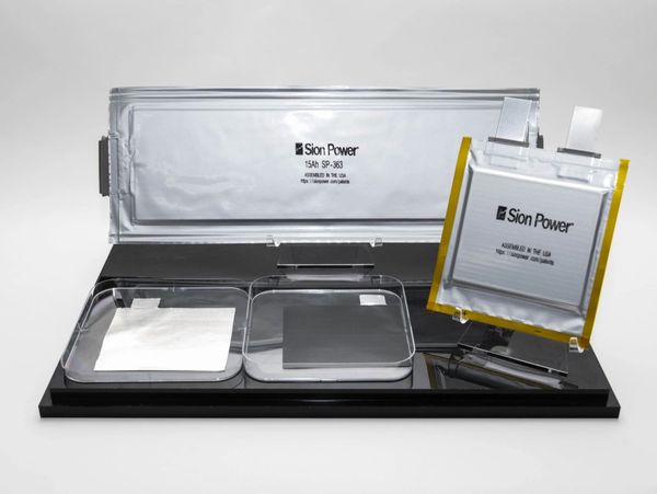 Various Sion Power lithium-ion battery cells displayed on a black platform.