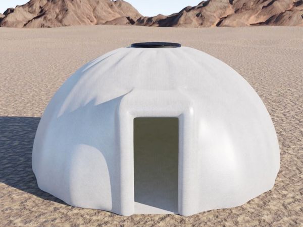 A white dome-shaped shelter in a desert landscape.