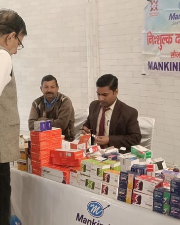 Medical professionals distributing free medicines at a health camp.