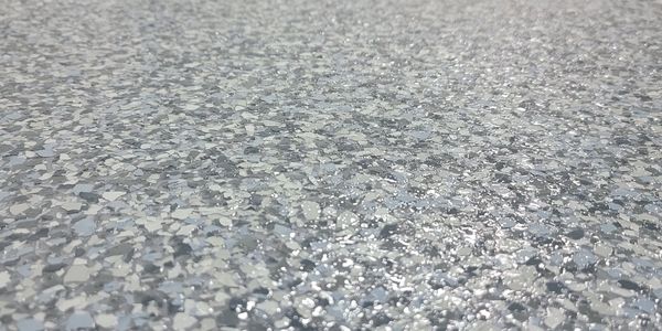 Close-up of a textured, speckled surface with a shiny finish.