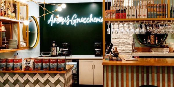 Cozy gnoccheria interior with warm lighting and stylish tiled counters.
