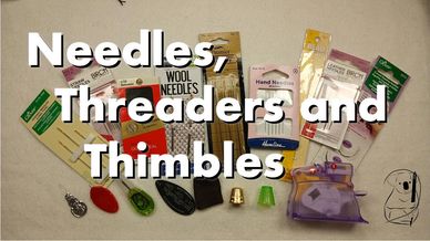 A selection of needles, threaders and thimbles