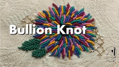 A large flower made of different coloured bullion knots