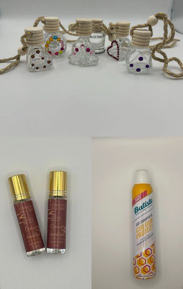 Decorative glass bottles and beauty products arranged on a white surface.