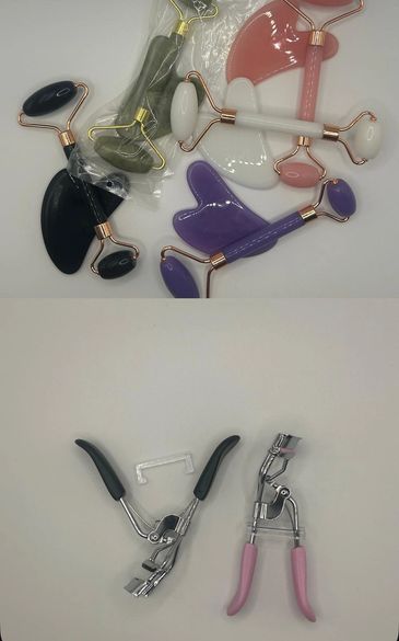 Various facial rollers and eyelash curlers on a white surface.