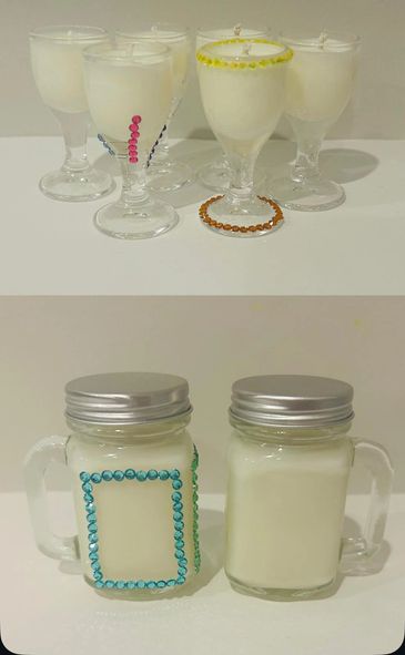 Decorative candles in glassware and jars with colorful beads.