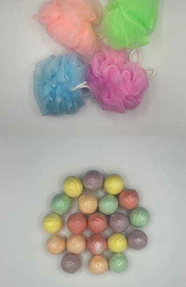 Colorful bath loofahs and assorted bath bombs on a white surface.