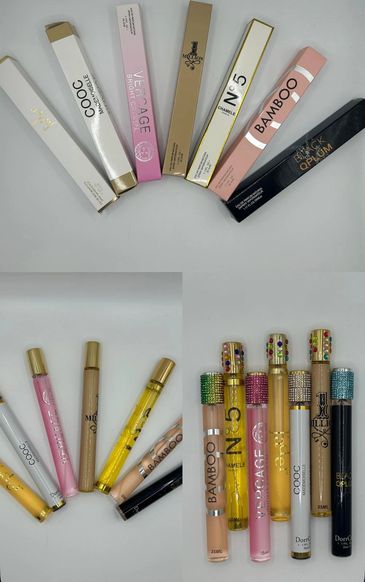 A collection of perfume boxes and bottles arranged neatly on a white surface.