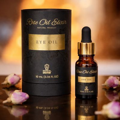 Luxurious Rose Oil Elixir Eye Oil in elegant packaging with rosebuds.