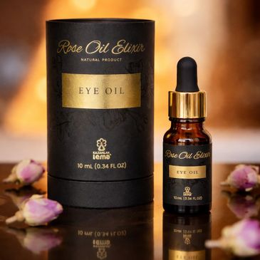 Elegant Rose Oil Elixir eye oil bottle and packaging with rosebuds.