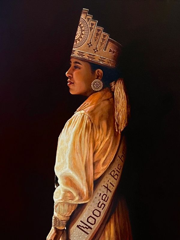 Portrait of a Native American woman in traditional attire and headdress.