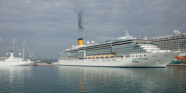 Yacht and cruise ship docked at port