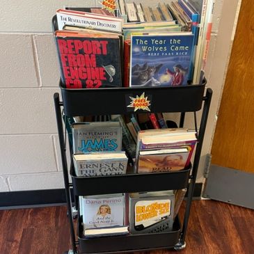 Black cart with multiple books.
