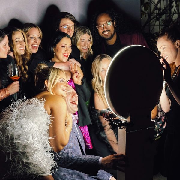 Friends gathered around a photo booth