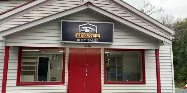 Small building with Alvarez Auto Sales sign.