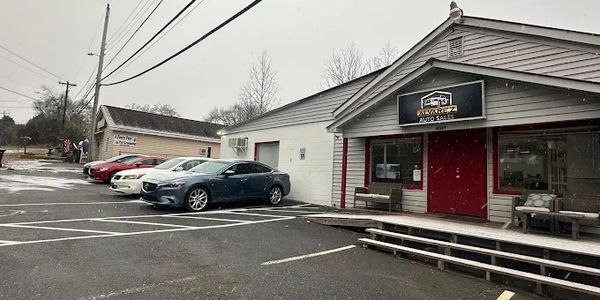 Car dealership parking lot on a cloudy day.