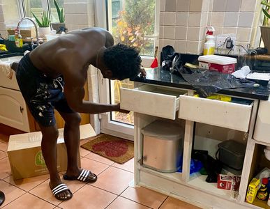 Black Man Cleaning Kitchen Tiles