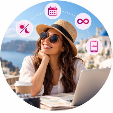 Woman enjoying work outdoors with laptop and coffee.