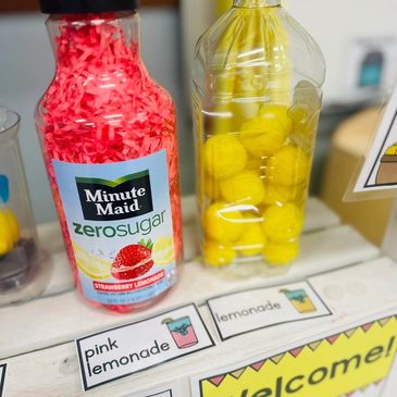 image of lemonade stand dramatic play center printables and props set up in a preschool clasroom