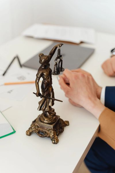 Bronze Lady Justice statue on desk.