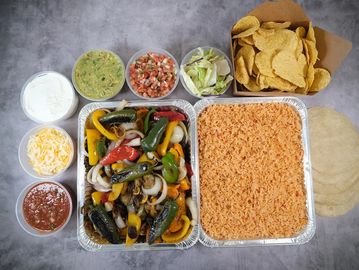 Mexican meal with rice, grilled veggies, and tortillas.