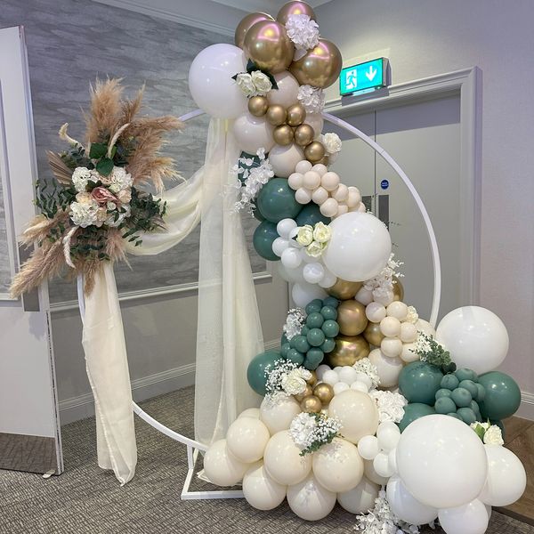 Wedding Balloon Moongate arch Backdrop set up at Thorpe Park Leeds. Colours sage green, cream, white
