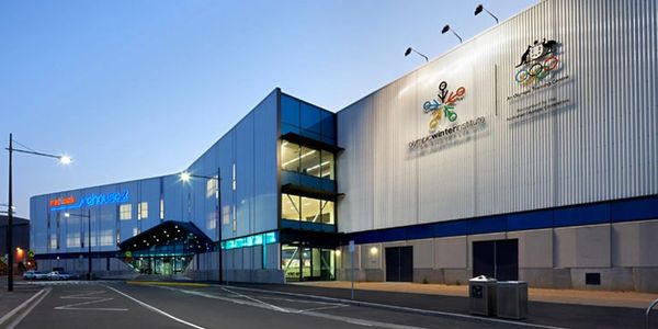 Evening view of the Olympic Winter Institute building with logos and clear sky.