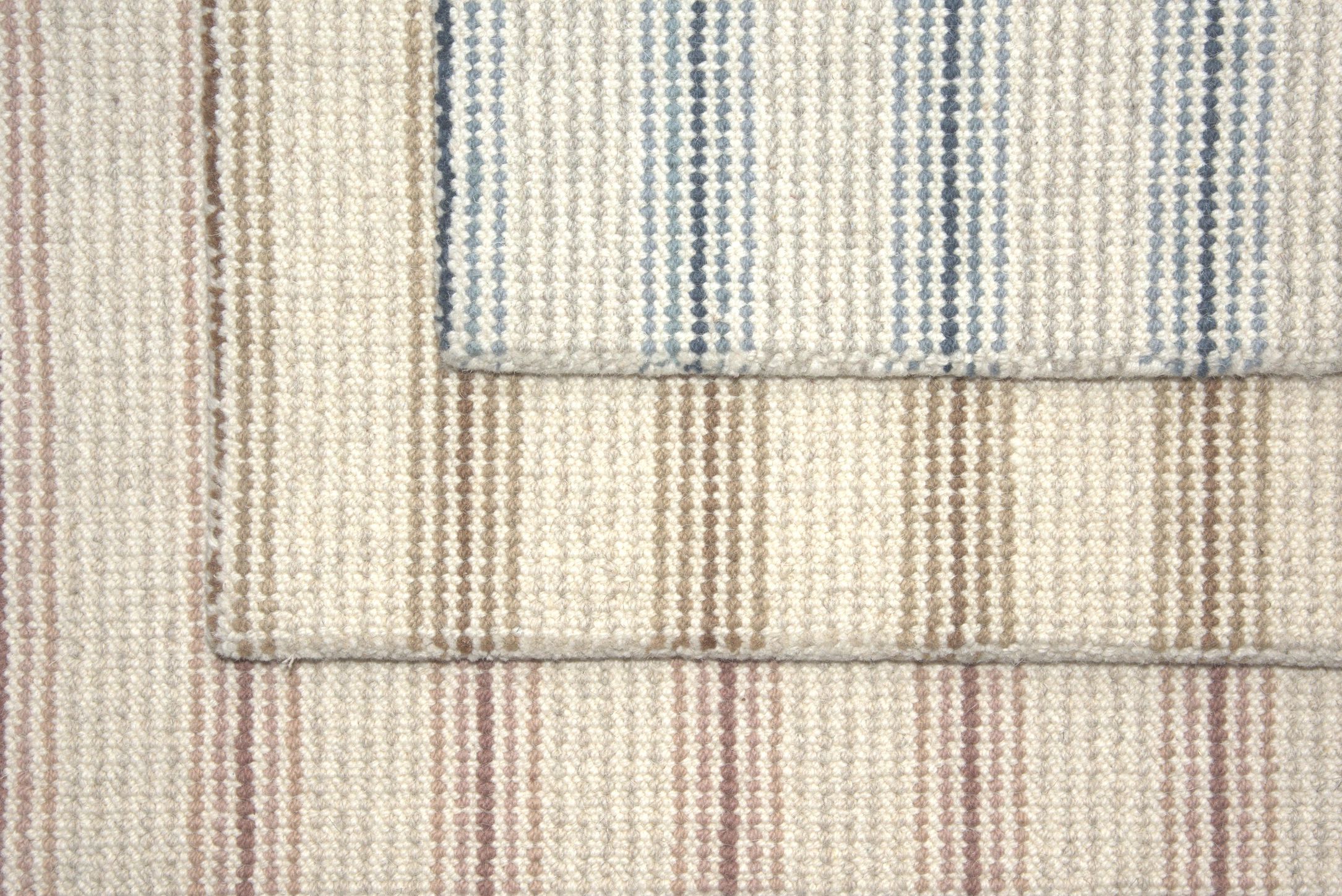 Two textured rugs with striped patterns in neutral colors.