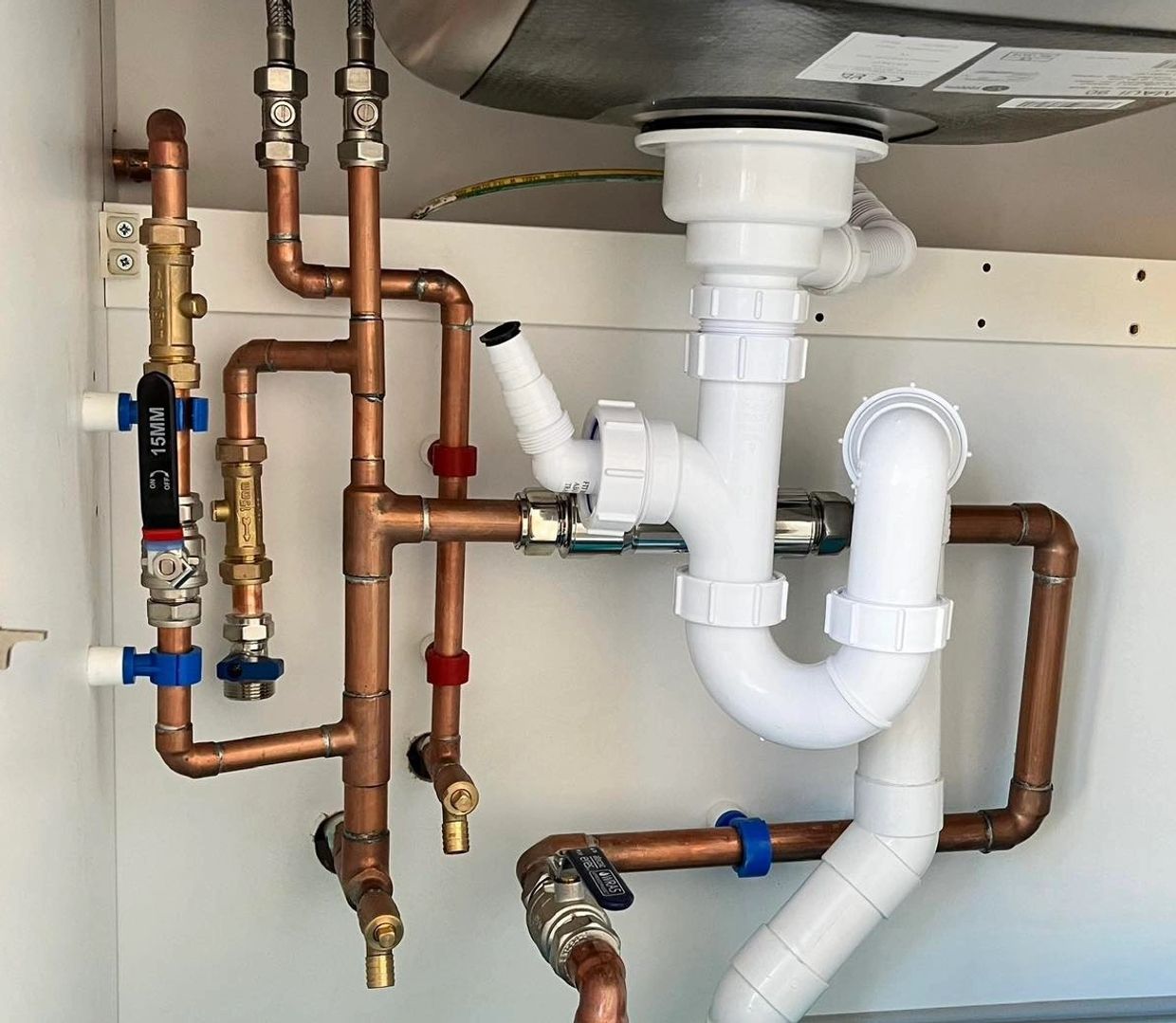 Repiped plumber installing sink pipework in Tiptree, Essex